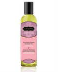 Aromatic massage oil bottle with black cap, yellow-green glass and pink label