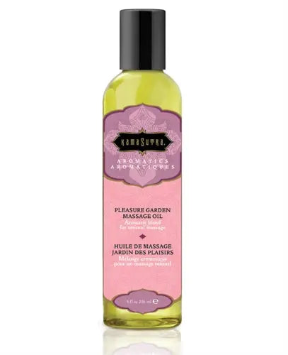 Aromatic massage oil bottle with black cap, yellow-green glass and pink label