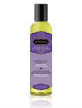 Massage oil bottle with black cap, yellow liquid, Harmony blend label