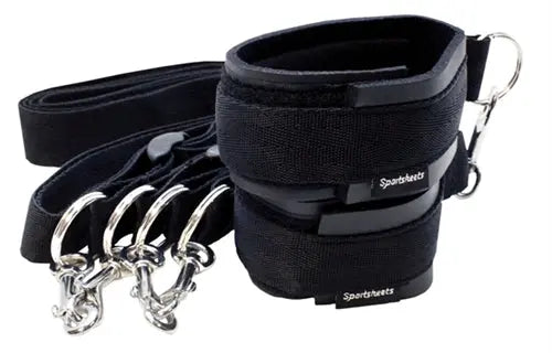 Black fabric sports cuffs set with metal rings and attached tethers, adjustable loops