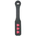 Leather impression paddle with heart-shaped pink accents and stitched black handle