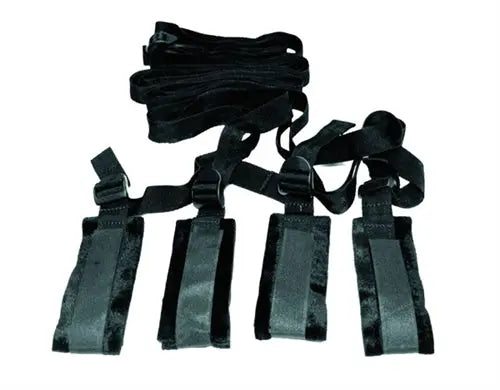 Bed bondage restraint strap kit with black fabric straps and padded panels