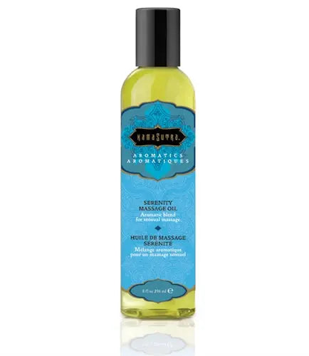 Aromatic massage oil bottle with yellow liquid and blue Serenity label