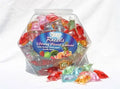 Assorted warming lubricant pieces in a clear plastic jar with wrapped pieces