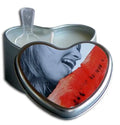 Heart-shaped candle with red watermelon slice inside dark metal tin