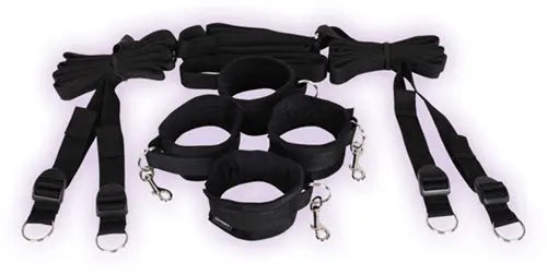 Under-bed restraint system with black fabric straps and metal clasps, multiple cuffs