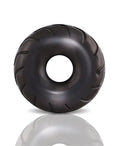 Black truck tire with central hole, molded tread detail