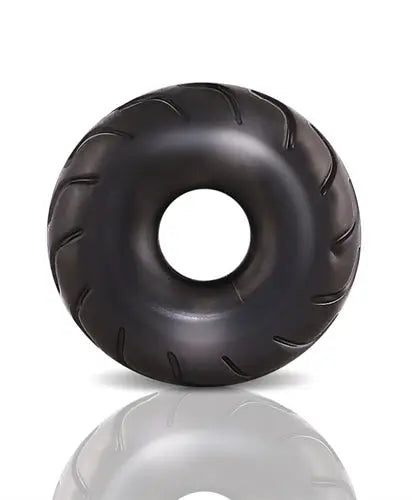 Black truck tire with central hole, molded tread detail