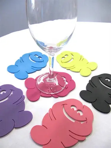 Set of six colorful novelty pecker-shaped drink coasters, round silicone-like pieces