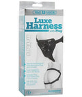 Black adjustable luxe harness with plug, shown on packaging box