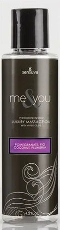 Massage oil bottle with black cap; label shows pomegranate fig, coconut, plumeria