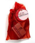 Red fabric gift bag with large bow and round charm tag