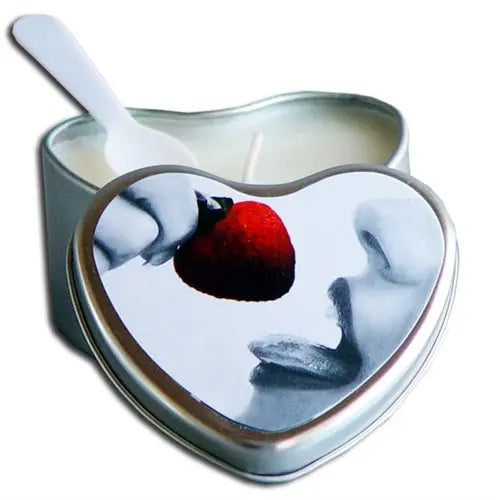 Heart-shaped candle with white wax and red strawberry decoration in metal tin