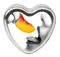Heart-shaped metal candle with peach wax crescent and grey wax face details