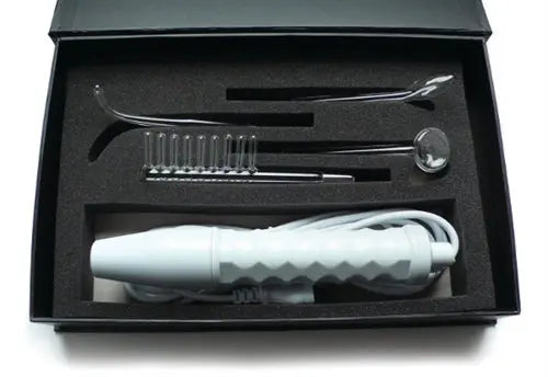 Electrosex wand kit with white handle and metallic accessory pieces in open box