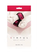Pink vinyl wrist cuffs with adjustable straps and buckle detail