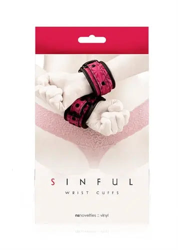 Pink vinyl wrist cuffs with adjustable straps and buckle detail