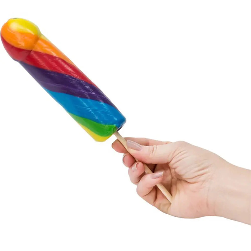 Jumbo rainbow striped pop toy with handle, held in a hand
