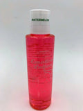 Watermelon lotion bottle with red liquid and white cap