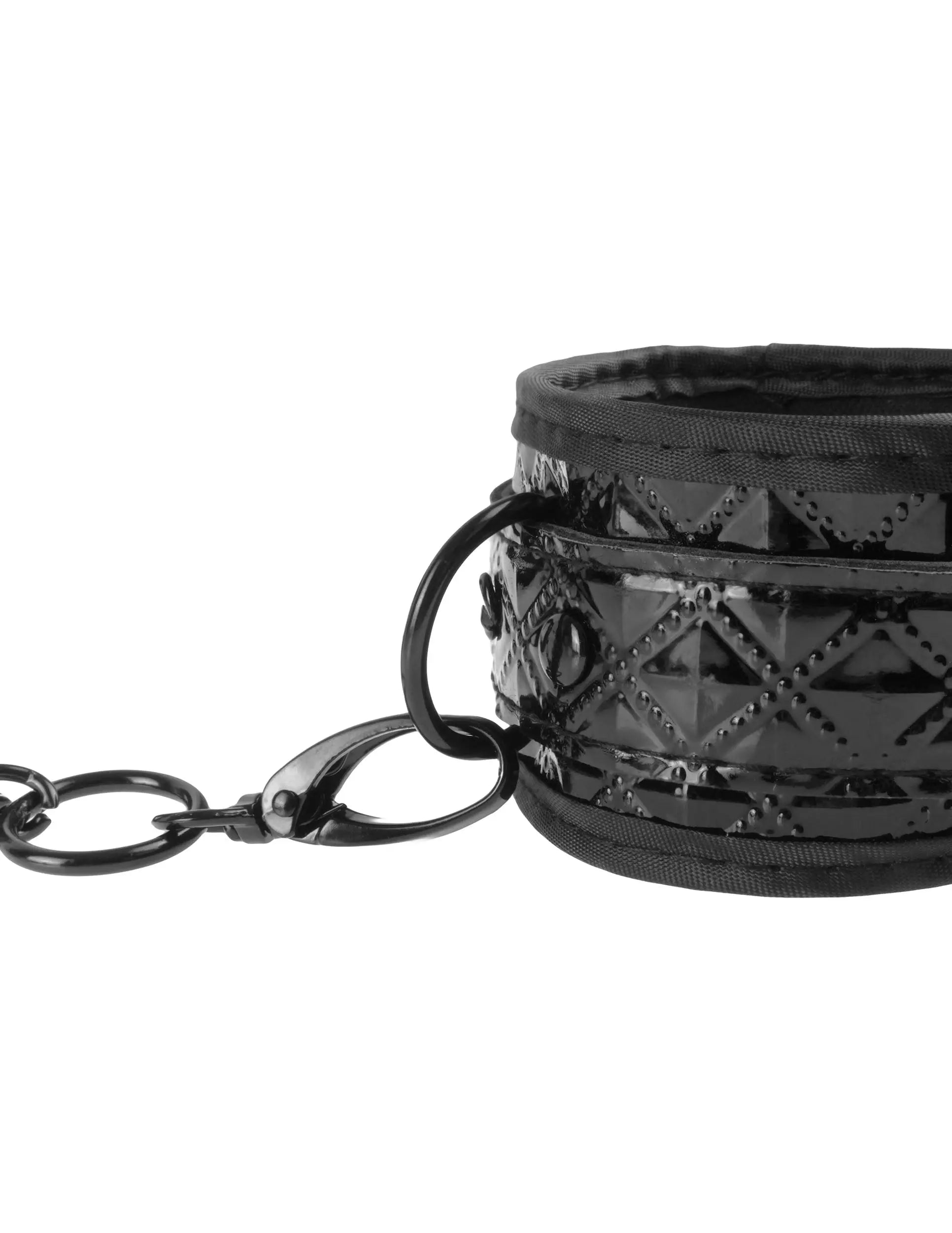 Black couture cuff with chain and studded metal trim