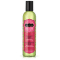 Massage oil bottle with green liquid and strawberry pink label, black cap.
